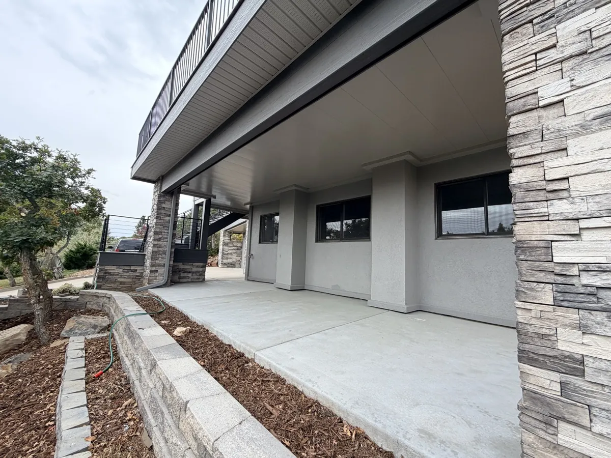 Modern commercial building exterior with Undercover Systems underdeck ceiling on a covered walkway, Colorado