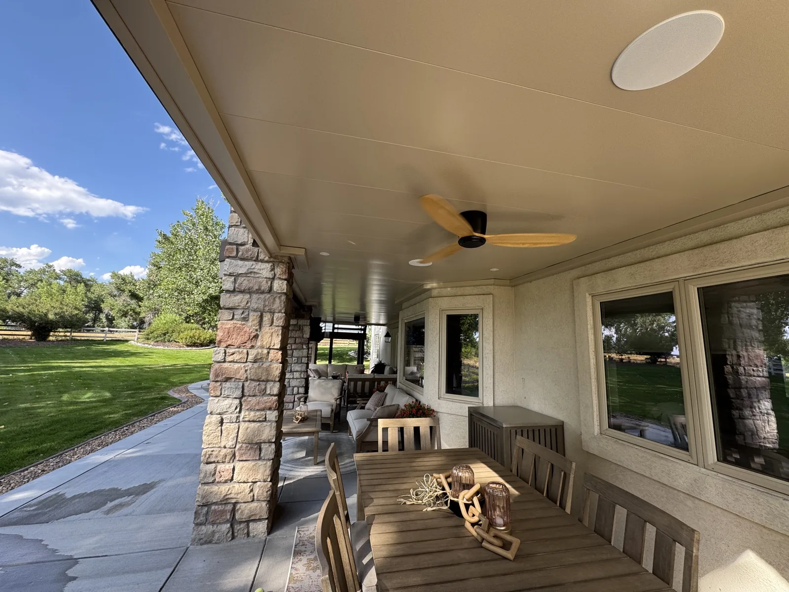 Modern two-blade ceiling fan with wood-tone finish on a smooth underdeck ceiling, Colorado