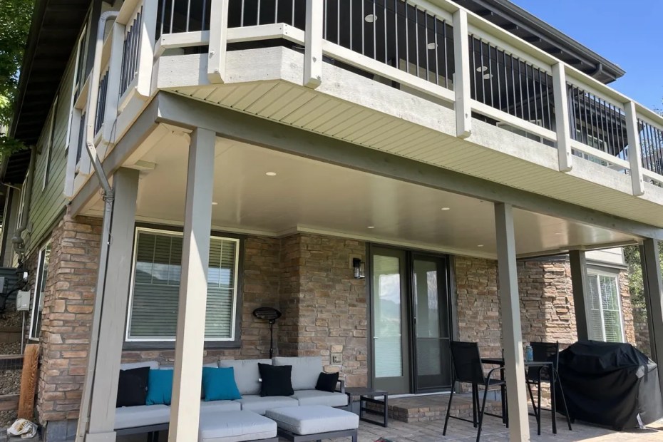 Clean white underdeck ceiling system over a covered patio in Castle Rock, CO
